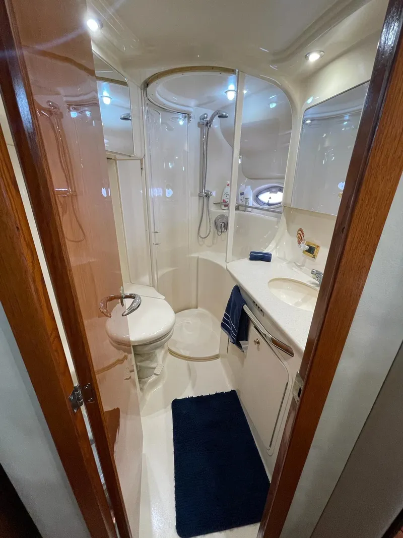 Slide: The Image of 2000 Sea Ray 450 Express Bridge bathroom with shower and sink. - 10