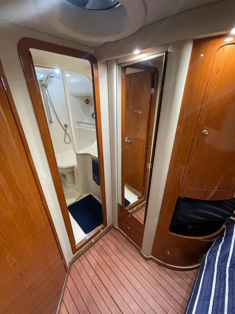 Slide: The Image of Interior of 2000 Sea Ray 450 Express Bridge yacht with wooden finishes and bathroom. - 13