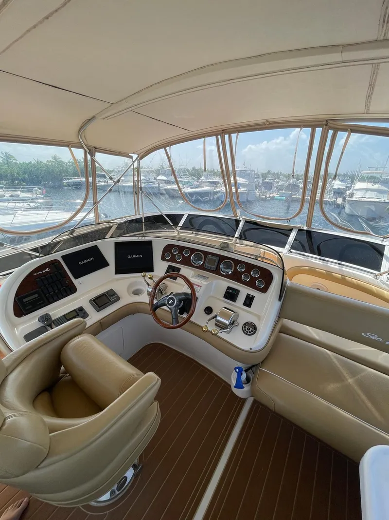 Slide: The Image of Helm of 2000 Sea Ray 450 Express Bridge yacht with leather seating and modern controls. - 2