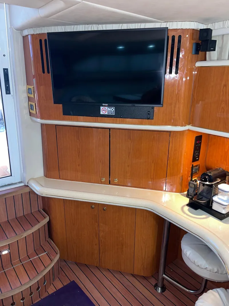 Slide: The Image of Interior of 2000 Sea Ray 450 Express Bridge with TV and coffee station. - 21