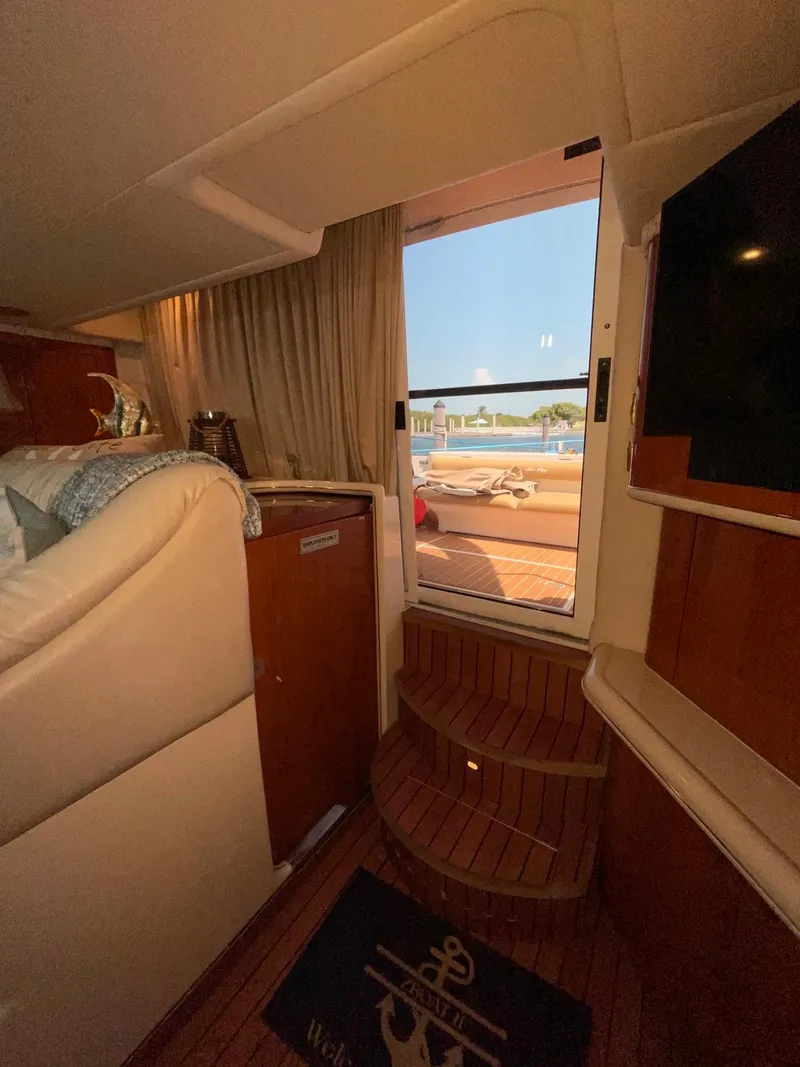 Slide: The Image of Interior of 2000 Sea Ray 450 Express Bridge yacht with view of deck and water. - 22