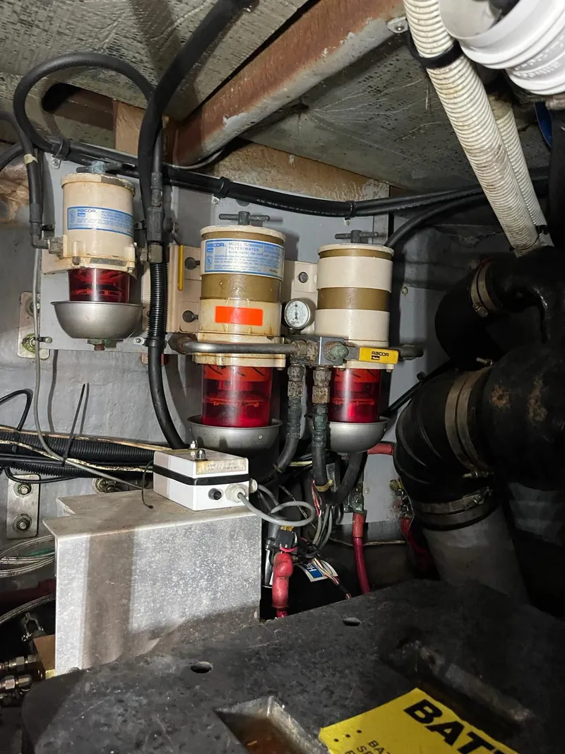Slide: The Image of Engine room of a 2000 Sea Ray 450 Express Bridge with fuel filters and wiring. - 25