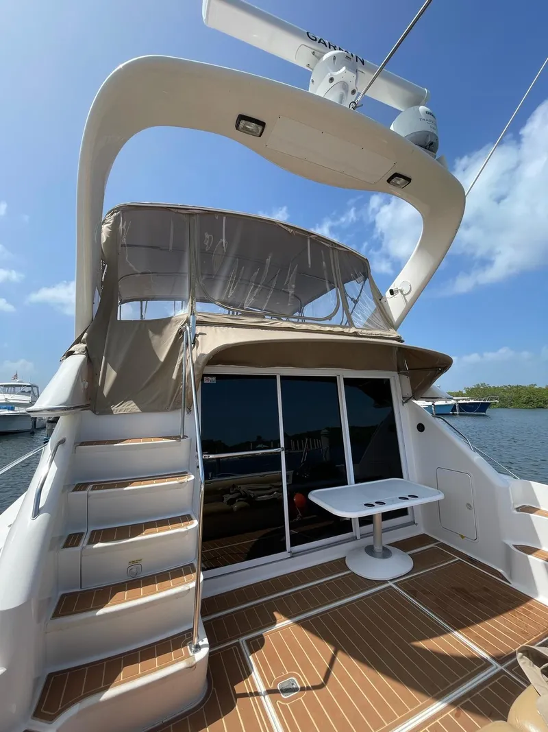 Slide: The Image of 2000 Sea Ray 450 Express Bridge yacht with upper deck and outdoor seating. - 27