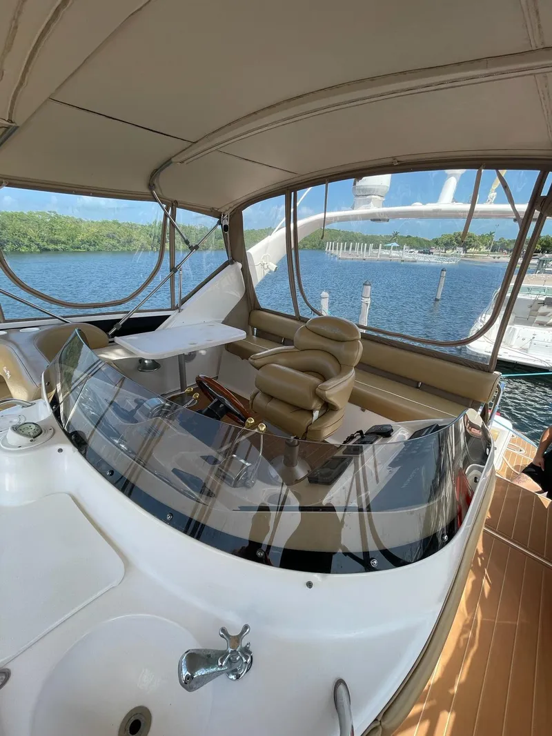 Slide: The Image of 2000 Sea Ray 450 Express Bridge yacht interior with helm and seating. - 3
