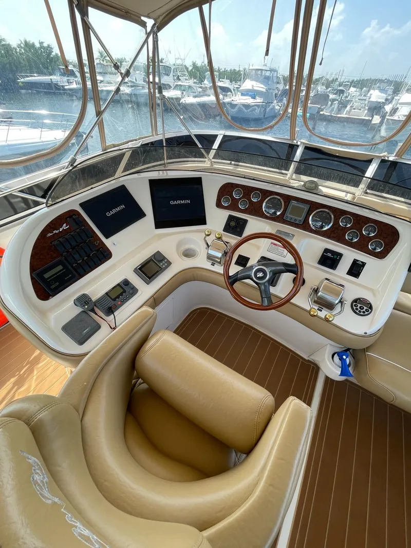 Slide: The Image of Helm of 2000 Sea Ray 450 Express Bridge with leather seating and advanced navigation controls. - 5