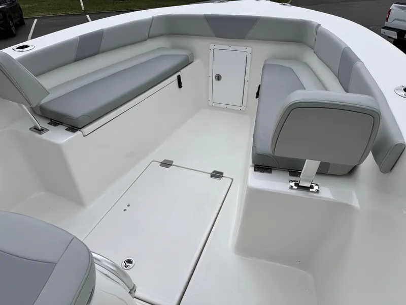 Slide: The Image of 2024 KenCraft 21 Center Console boat with cushioned seating and storage compartments. - 19