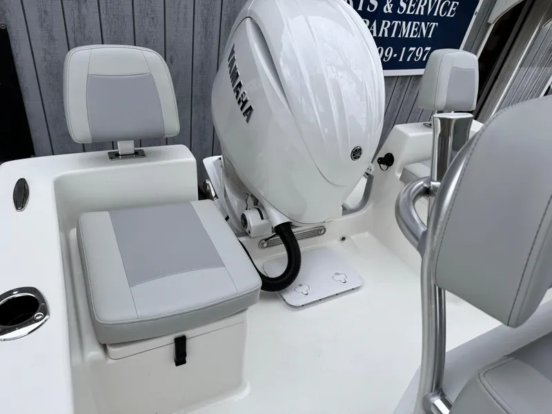 Slide: The Image of 2024 KenCraft 21 Center Console boat with Yamaha outboard motor and cushioned seating. - 4