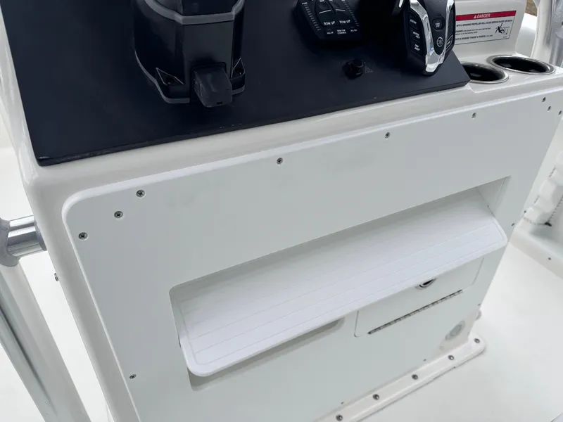 Slide: The Image of 2024 KenCraft 21 Center Console boat dashboard with storage compartments. - 9