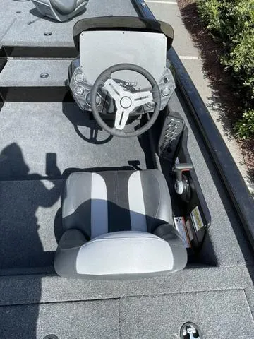 Slide: The Image of 2023 Vexus AVX181 boat cockpit with steering wheel and captain's seat. - 7