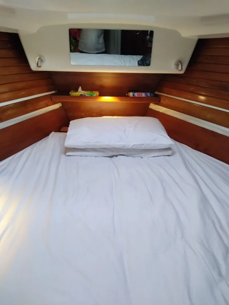 Slide: The Image of Cabin of Jeanneau Sun Odyssey 40.3, 2005 model, featuring a cozy bed. - 13