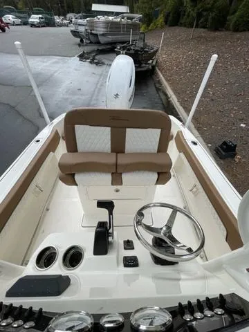 Slide: The Image of 2024 Pioneer Sportfish 202 boat interior with steering wheel and seating. - 12