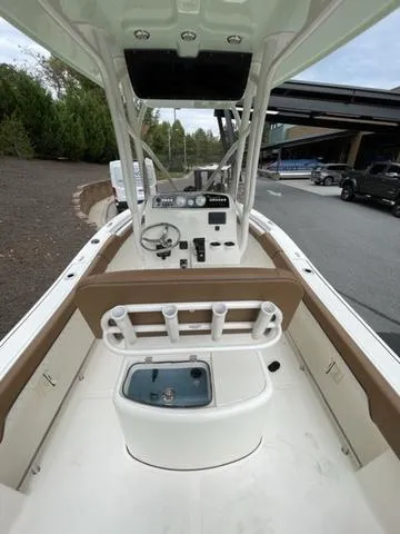 Slide: The Image of 2024 Pioneer Sportfish 202 boat interior with console and rod holders. - 5