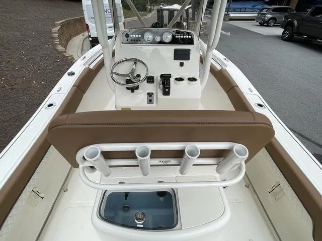 Slide: The Image of 2024 Pioneer Sportfish 202 boat interior with steering console and rod holders. - 6