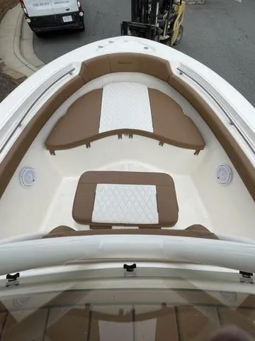 Slide: The Image of 2024 Pioneer Sportfish 202 boat interior with cushioned seating and white accents. - 8