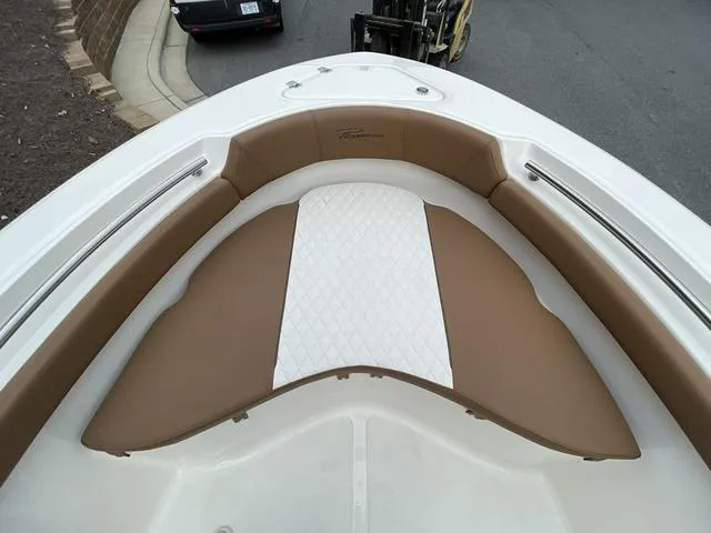 Slide: The Image of 2024 Pioneer Sportfish 202 boat bow seating area with tan and white cushions. - 9