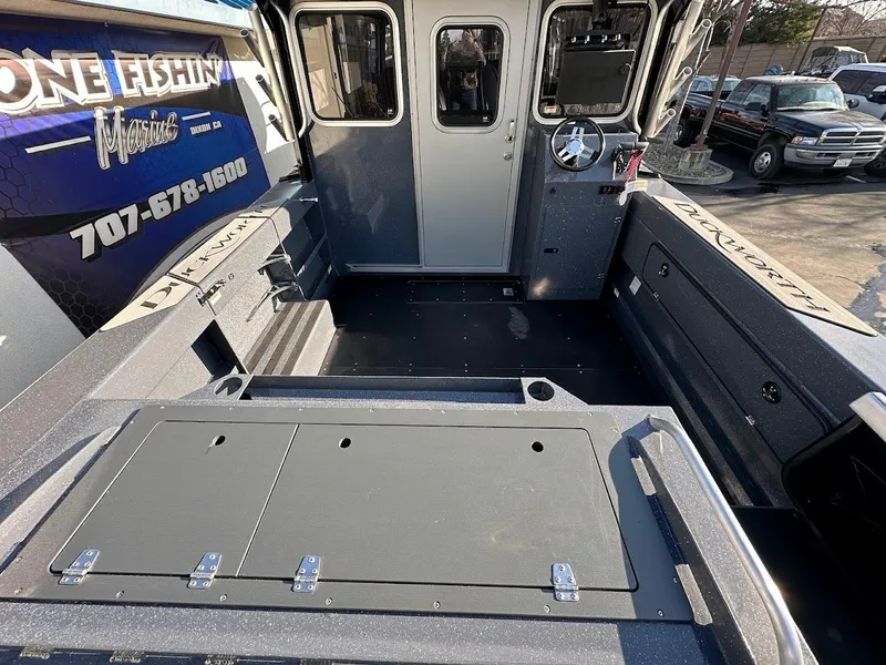 Slide: The Image of 2024 Duckworth 26 Offshore boat interior with spacious deck and modern controls. - 11