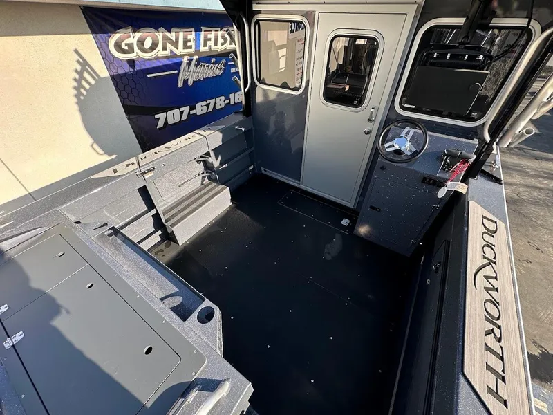 Slide: The Image of 2024 Duckworth 26 Offshore boat interior with seating and control panel. - 13