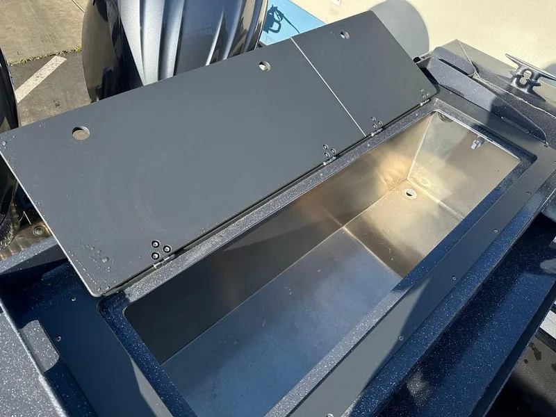 Slide: The Image of 2024 Duckworth 26 Offshore boat storage compartment, open lid, stainless steel interior. - 17