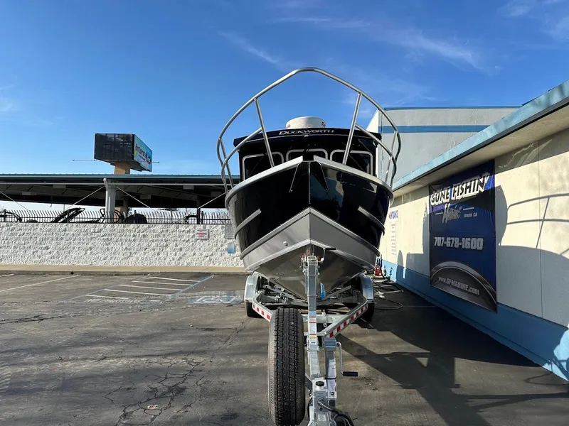 Slide: The Image of 2024 Duckworth 26 Offshore boat on trailer, parked outdoors under clear sky. - 3