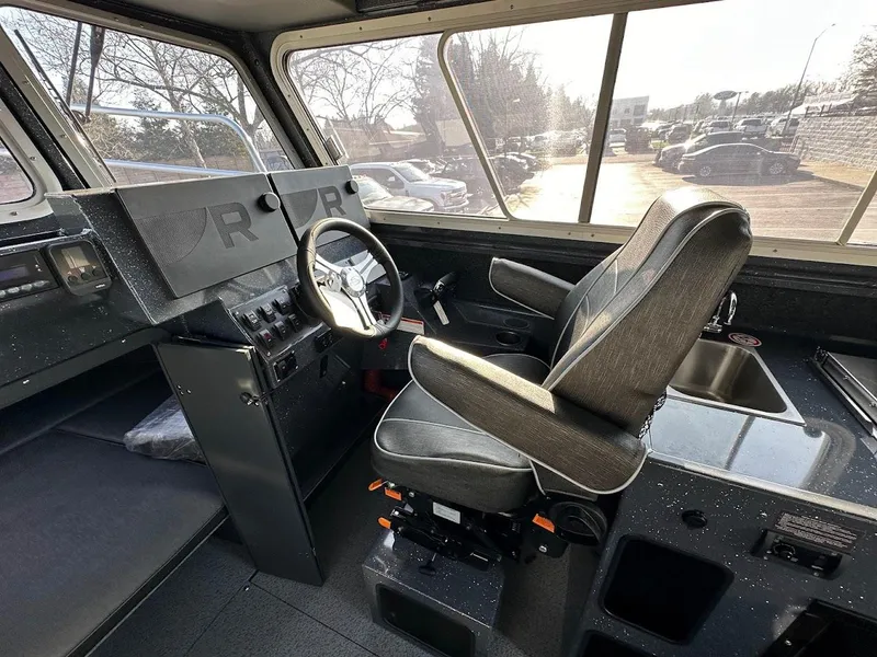 Slide: The Image of Interior of 2024 Duckworth 26 Offshore boat, featuring helm and seating area. - 32