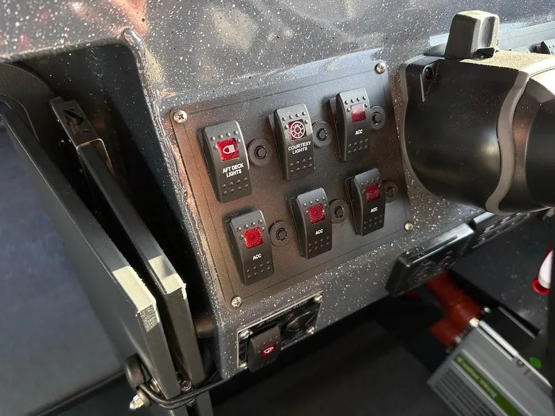 Slide: The Image of Control panel of 2024 Duckworth 26 Offshore boat with switches and steering wheel. - 39
