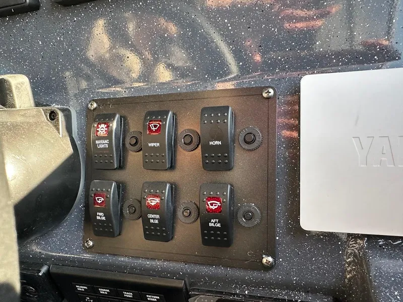 Slide: The Image of Control panel of 2024 Duckworth 26 Offshore boat with labeled switches. - 40
