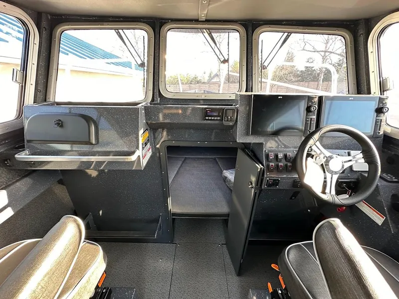 Slide: The Image of 2024 Duckworth 26 Offshore boat interior with steering wheel and navigation screens. - 41