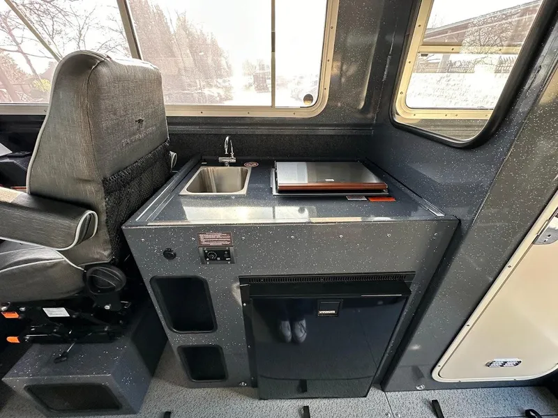 Slide: The Image of 2024 Duckworth 26 Offshore interior with sink, countertop, and compact fridge. - 45