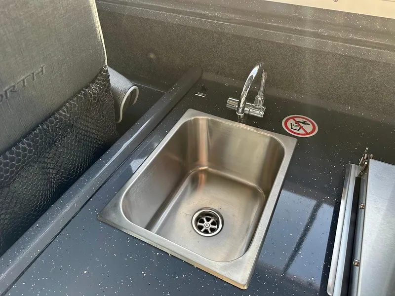 Slide: The Image of 2024 Duckworth 26 Offshore boat sink with faucet and no-smoking sign. - 46