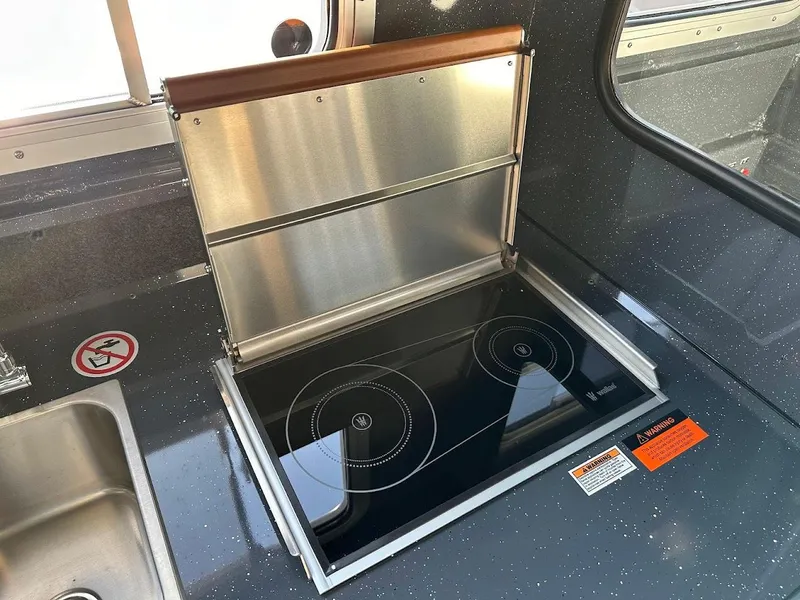 Slide: The Image of 2024 Duckworth 26 Offshore boat kitchen with electric stove and sink. - 47