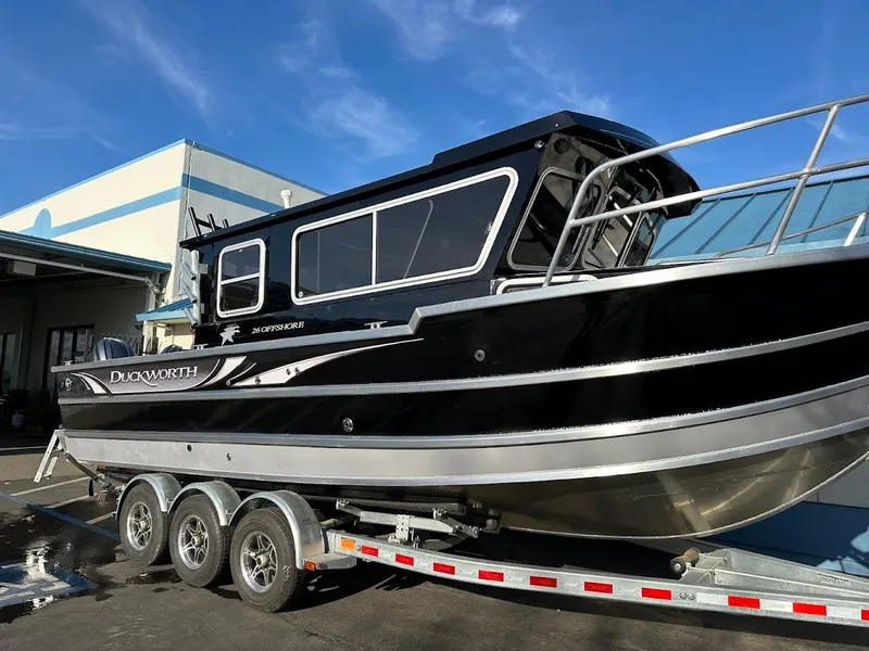 Slide: The Image of 2024 Duckworth 26 Offshore boat on trailer, black exterior, parked outdoors. - 6