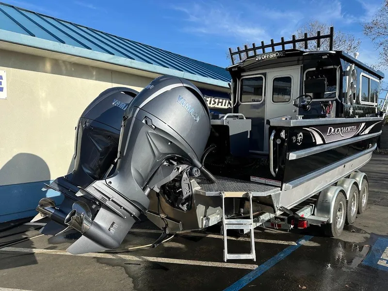 Slide: The Image of 2024 Duckworth 26 Offshore boat with dual outboard motors on a trailer. - 8