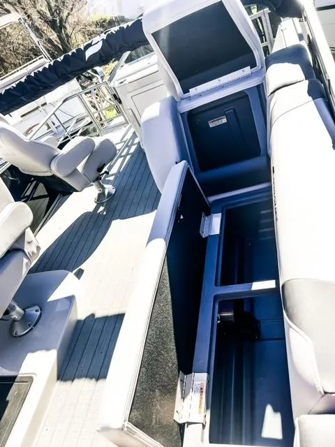 Slide: The Image of 2024 Starcraft CX 23 FD boat interior with open storage compartments. - 13