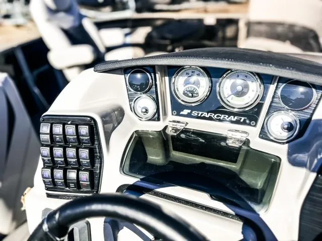 Slide: The Image of 2024 Starcraft CX 23 FD boat dashboard with gauges and control panel. - 2