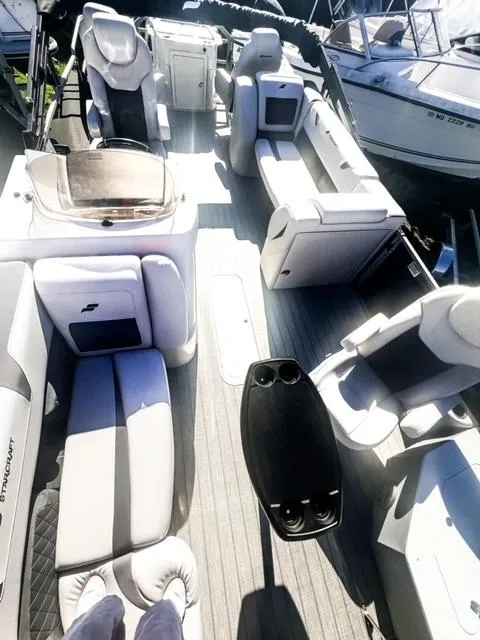 Slide: The Image of 2024 Starcraft CX 23 FD pontoon boat interior with luxurious seating and modern amenities. - 5