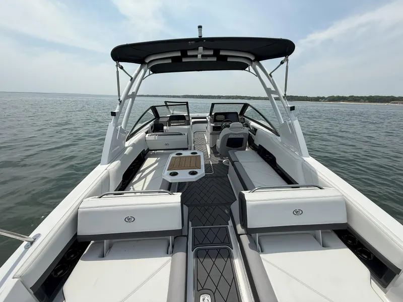 Slide: The Image of 2024 Cobalt R8 Outboard boat interior with seating, on a calm lake. - 15