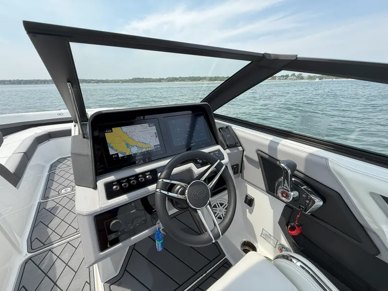 Slide: The Image of 2024 Cobalt R8 Outboard boat interior with modern dashboard and steering wheel on a sunny day. - 21