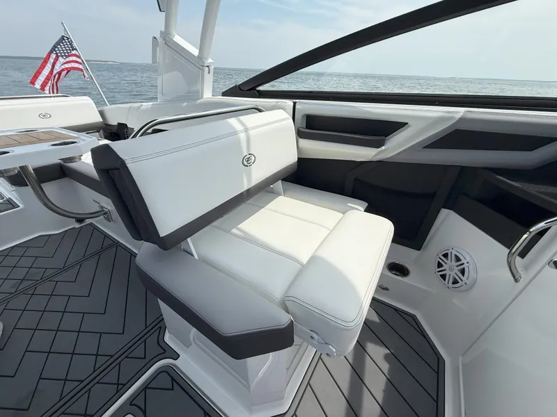 Slide: The Image of 2024 Cobalt R8 Outboard boat interior with white seating and American flag. - 24