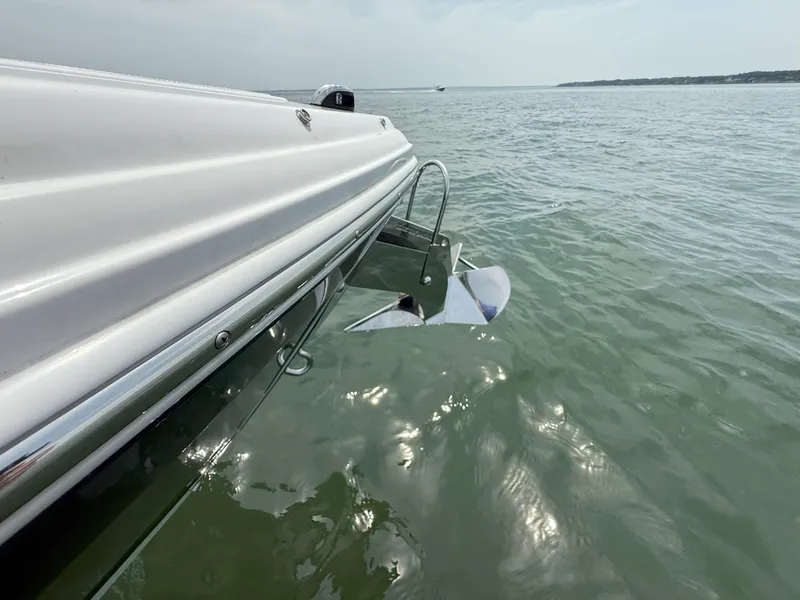 Slide: The Image of 2024 Cobalt R8 Outboard boat on water, showcasing sleek design and propeller. - 29