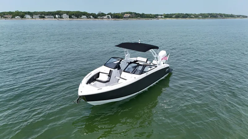 Slide: The Image of 2024 Cobalt R8 Outboard boat on calm water with distant shoreline. - 3
