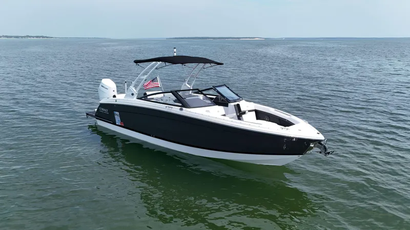 Slide: The Image of 2024 Cobalt R8 Outboard boat on calm water, featuring sleek design and American flag. - 4