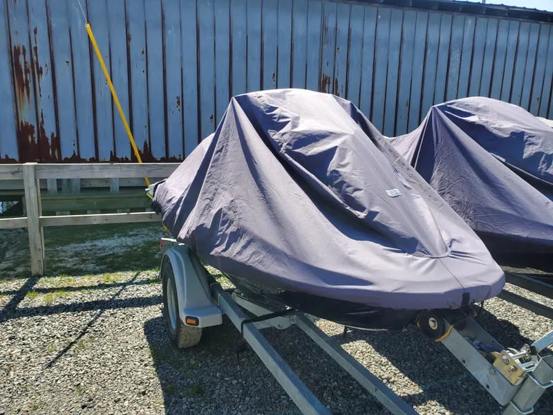 Slide: The Image of 2019 Yamaha WaveRunner EX Deluxe covered on a trailer, parked outdoors. - 3