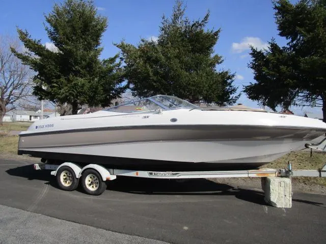 The Image of 1998 Four Winns 240 Horizon boat on a trailer, parked outdoors. - 1