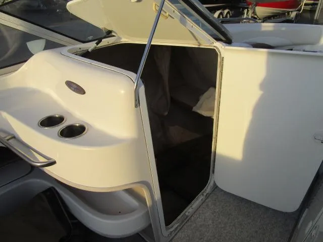 Slide: The Image of 1998 Four Winns 240 Horizon boat interior cabin entrance with cup holders. - 11