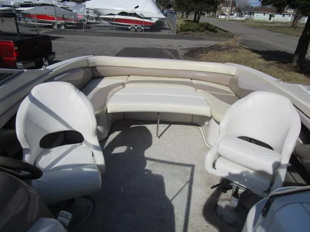 Slide: The Image of 1998 Four Winns 240 Horizon boat interior with white seating and carpeted floor. - 4