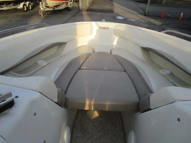 Slide: The Image of 1998 Four Winns 240 Horizon boat interior with cushioned seating. - 6