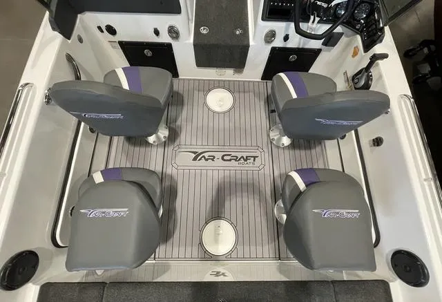 Slide: The Image of 2023 Yar-Craft 209 TFX boat interior with four grey seats and branded flooring. - 6