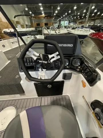 Slide: The Image of 2023 Yar-Craft 209 TFX boat dashboard with steering wheel and Humminbird electronics. - 8