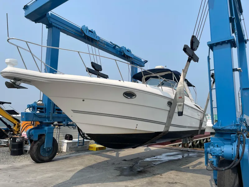 Slide: The Image of 2006 Monterey 322 Cruiser being lifted by a boat hoist. - 0
