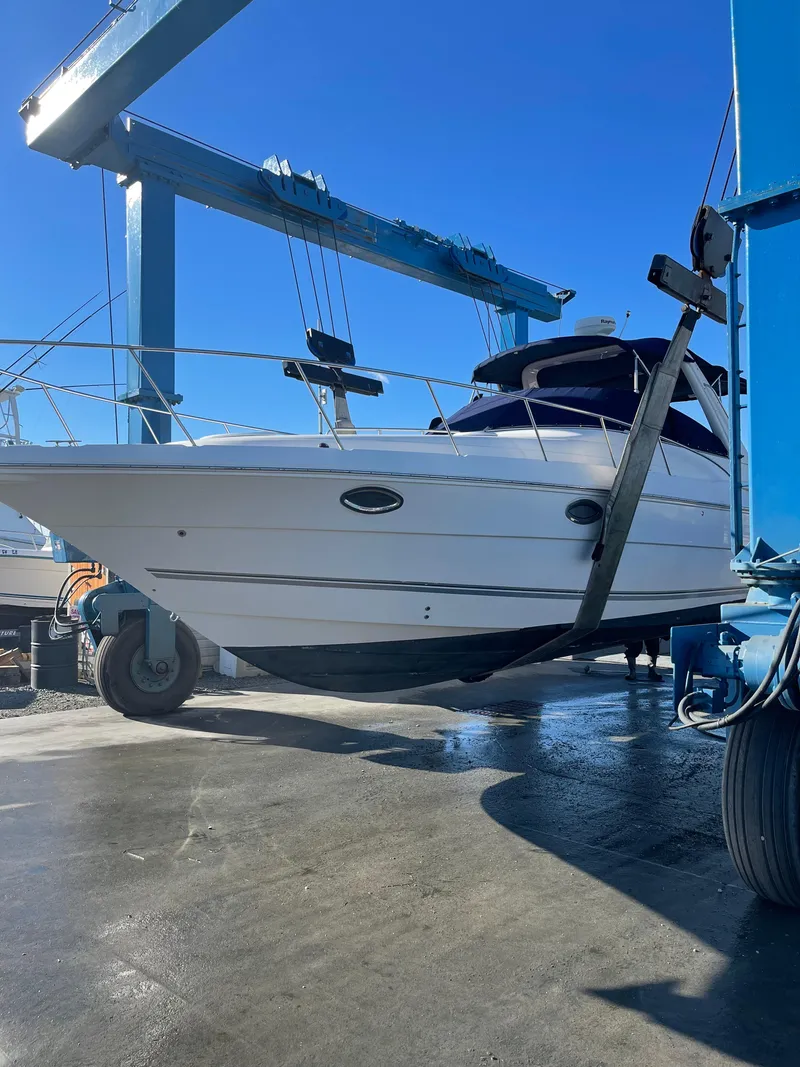 Slide: The Image of 2006 Monterey 322 Cruiser boat being lifted by a crane at a marina. - 1